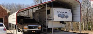 Double wide vehicle and RV cover built on a concrete slab.